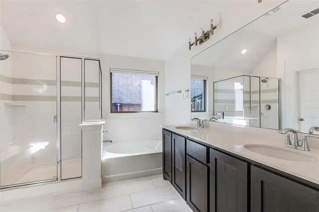 a bathroom with a granite countertop sink mirror and a bathtub