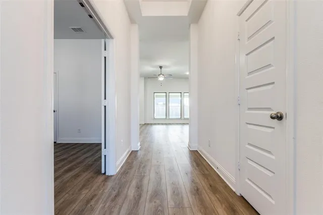 a view of hallway with wooden floor
