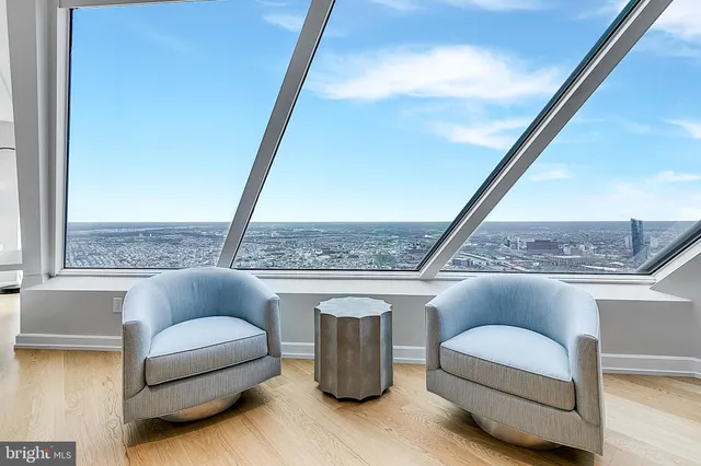 a living room with furniture and a floor to ceiling window