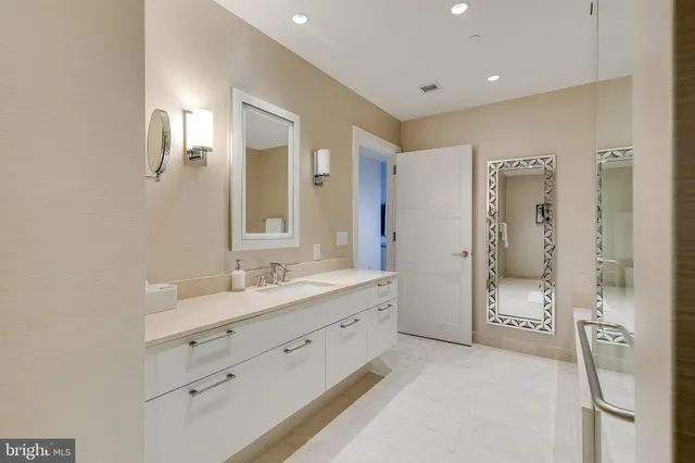 a bathroom with a double vanity sink mirror and shower