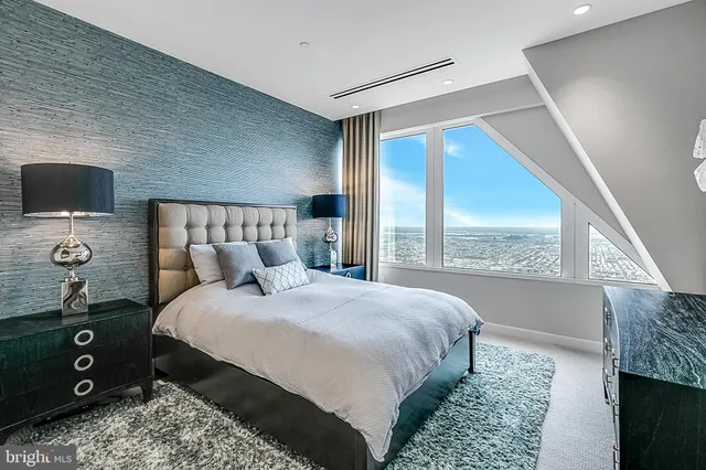 a bedroom with a bed and a tv