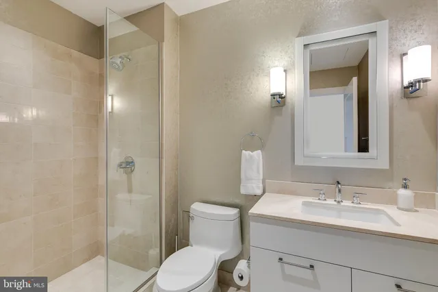 a bathroom with a sink toilet and shower