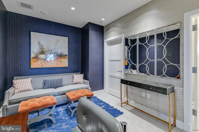 a living room with furniture a rug and a wall painting