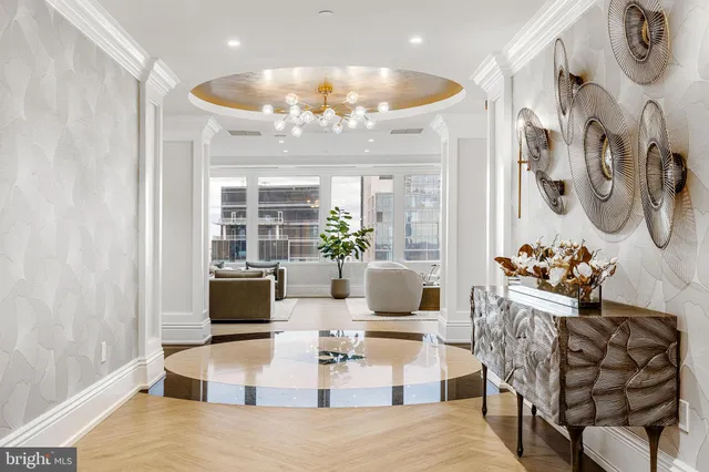 a living room with furniture and a chandelier
