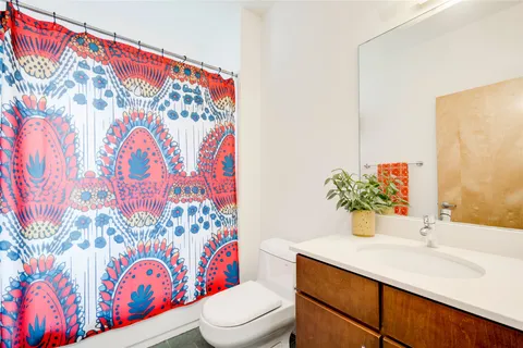 a bathroom with a sink mirror vanity and toilet