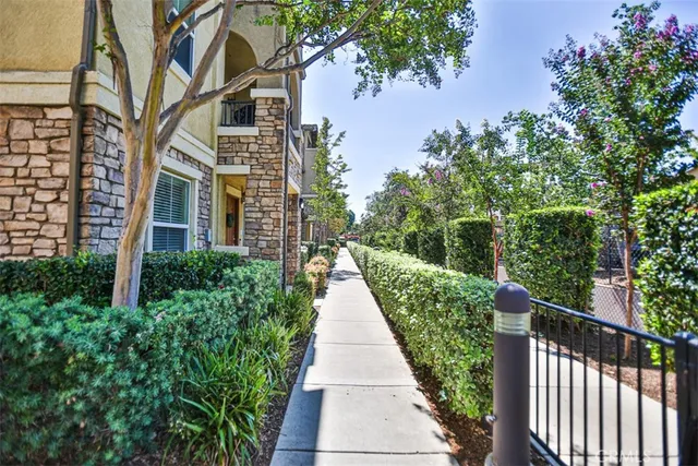 a view of a pathway with a garden