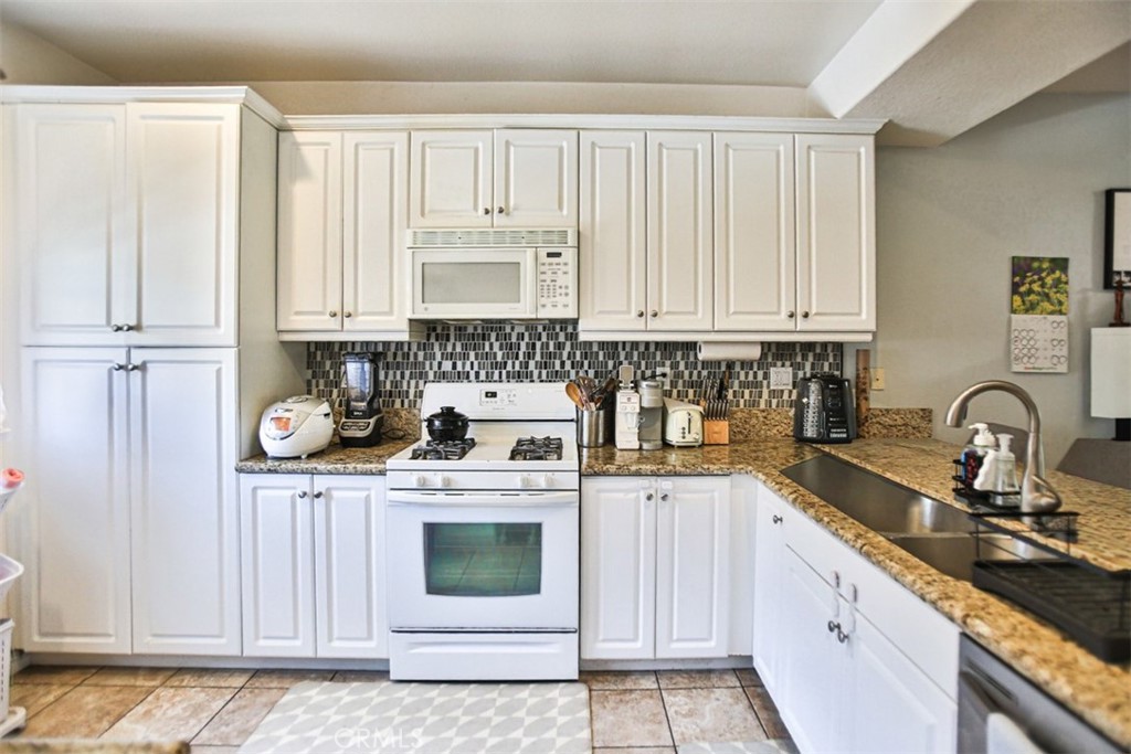8796 Aspenglow Place, Unit 2 Santee, CA 92071 - Photo 16 of 41 a kitchen with stainless steel appliances granite countertop a stove a sink and white cabinets