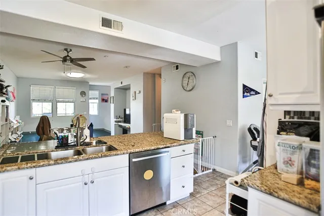 a kitchen with stainless steel appliances granite countertop a sink a stove and a refrigerator