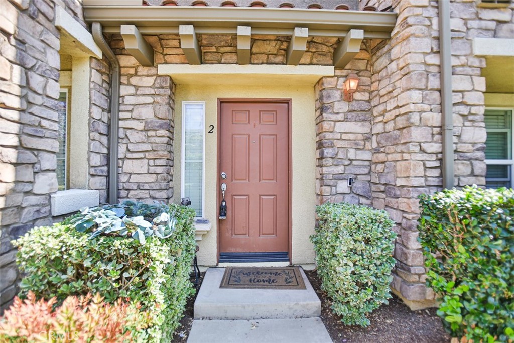 8796 Aspenglow Place, Unit 2 Santee, CA 92071 - Photo 2 of 41 a front view of a house with a garden