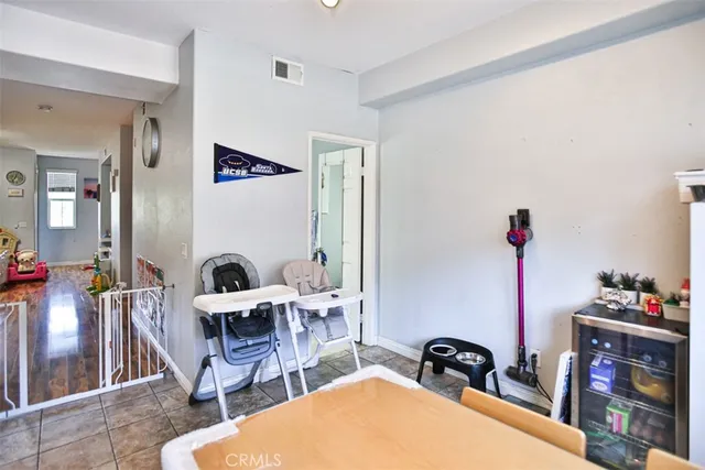 a living room with furniture a rug and white walls