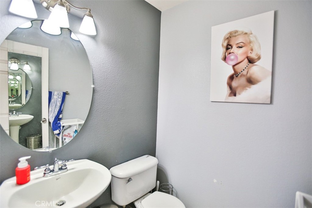 8796 Aspenglow Place, Unit 2 Santee, CA 92071 - Photo 23 of 41 a bathroom with a toilet sink and mirror