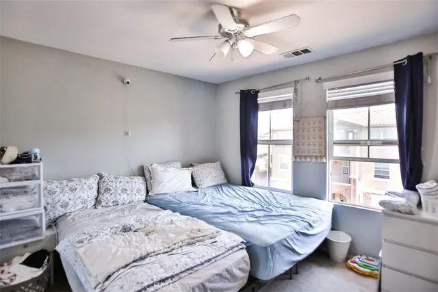 a bedroom with a bed and a large window