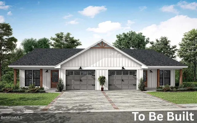 a view of a house with a yard and garage
