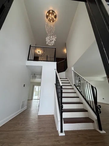 a view of entryway and hall with wooden floor