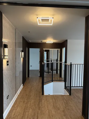 a view of a hallway with wooden floor