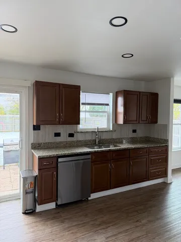a large kitchen with stainless steel appliances granite countertop a sink and a stove