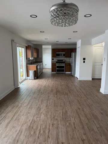a view of kitchen and kitchen with furniture wooden floor and window