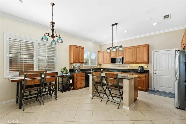 a kitchen with a dining table chairs and white cabinets