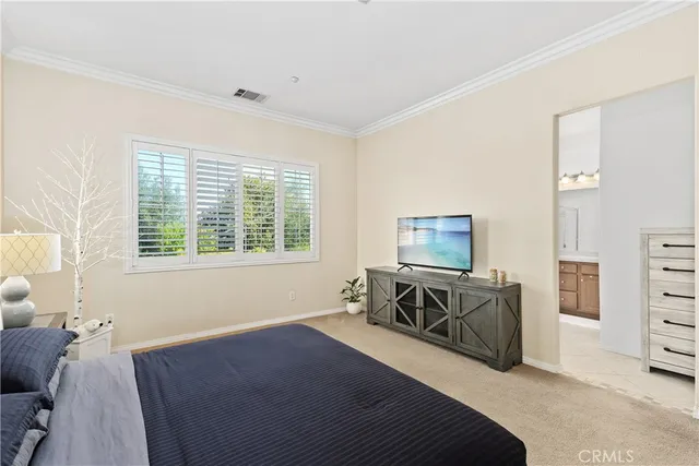a bedroom with furniture and a window