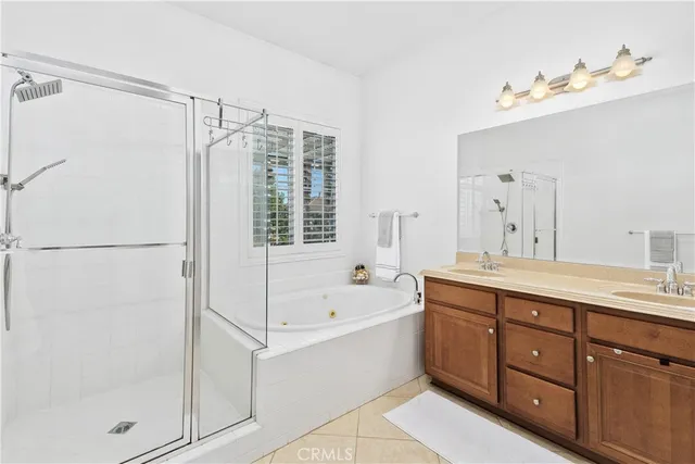 a spacious bathroom with a tub sink shower and mirror