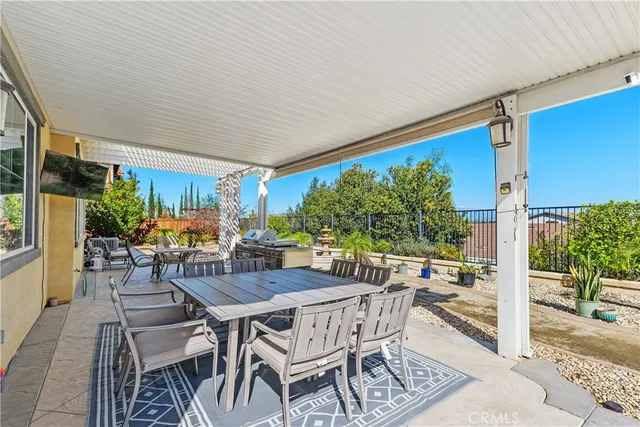 a front view of a house with swimming pool and furniture