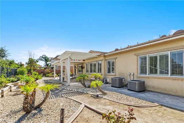 a view of a house with backyard patio and sitting area