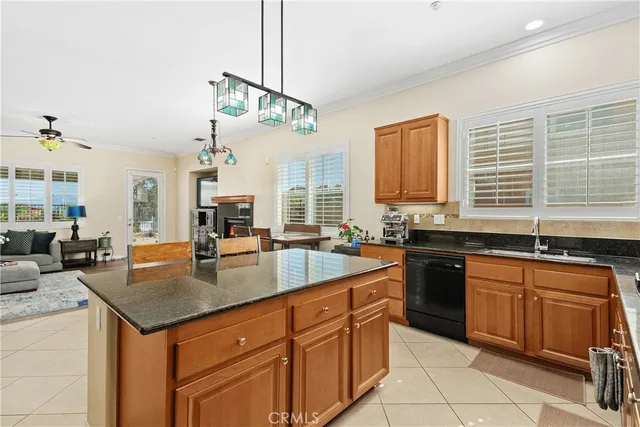 a kitchen with stainless steel appliances granite countertop a sink a stove counter space and cabinets