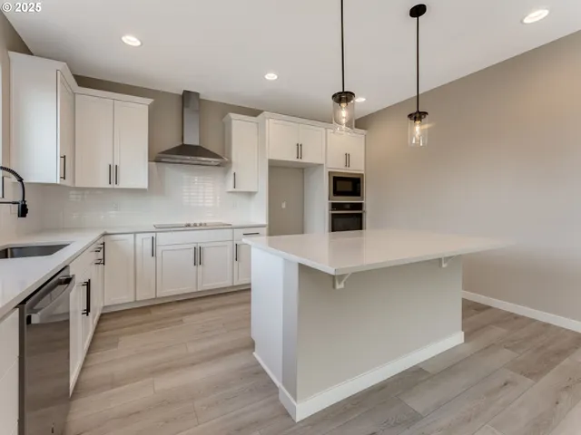 a kitchen with white cabinets and white appliances