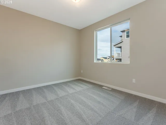a view of an empty room with closet area