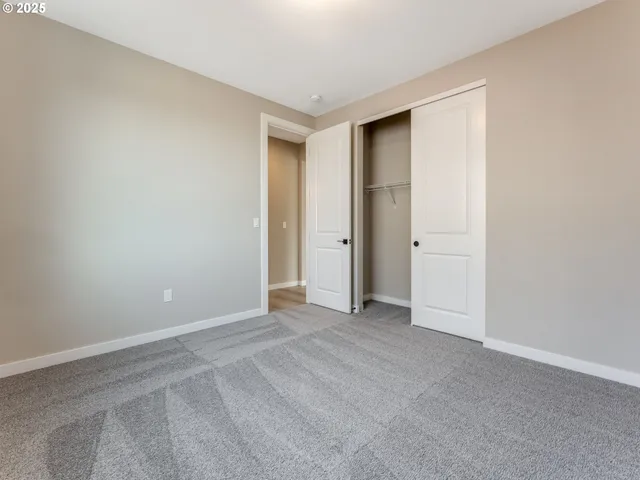 a bathroom with a granite countertop toilet sink and mirror