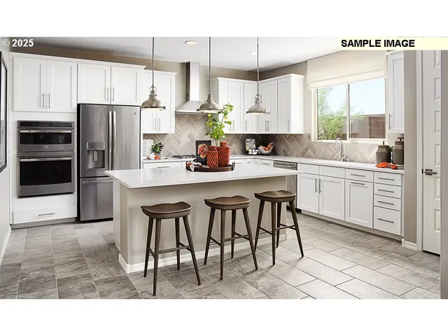 a kitchen with stainless steel appliances kitchen island granite countertop a table chairs sink and cabinets