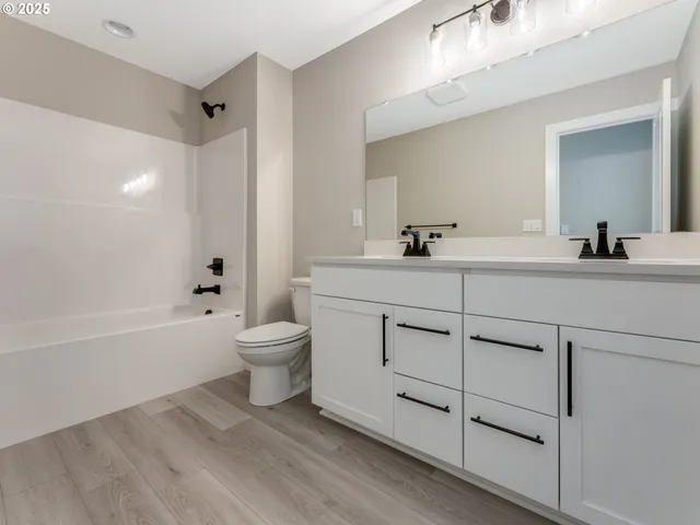 a room with a sink cabinets and wooden floor