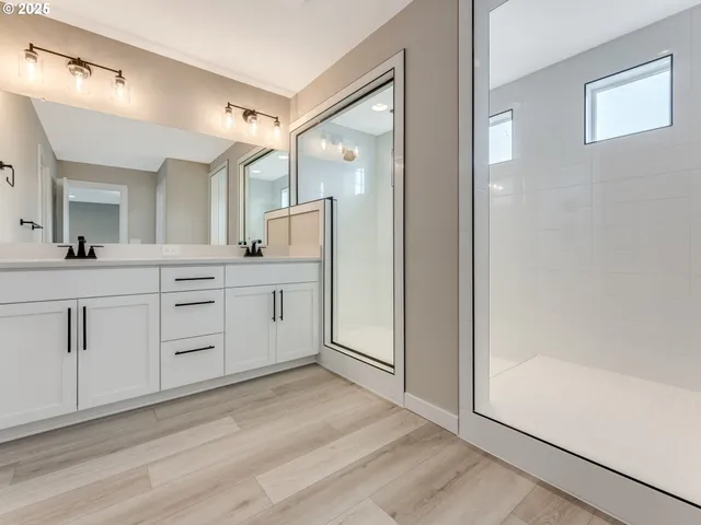 a view of a hallway with wooden floor and cabinets