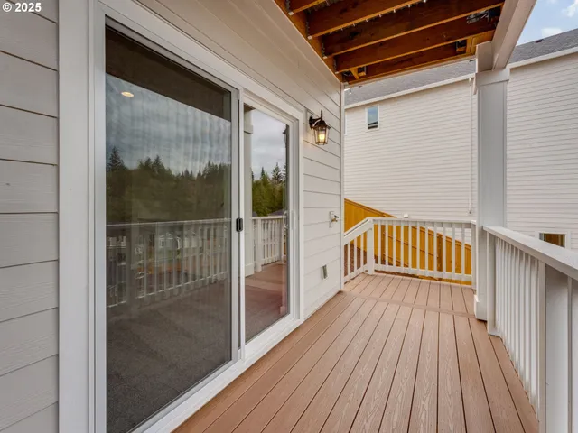 a view of a balcony with wooden floor