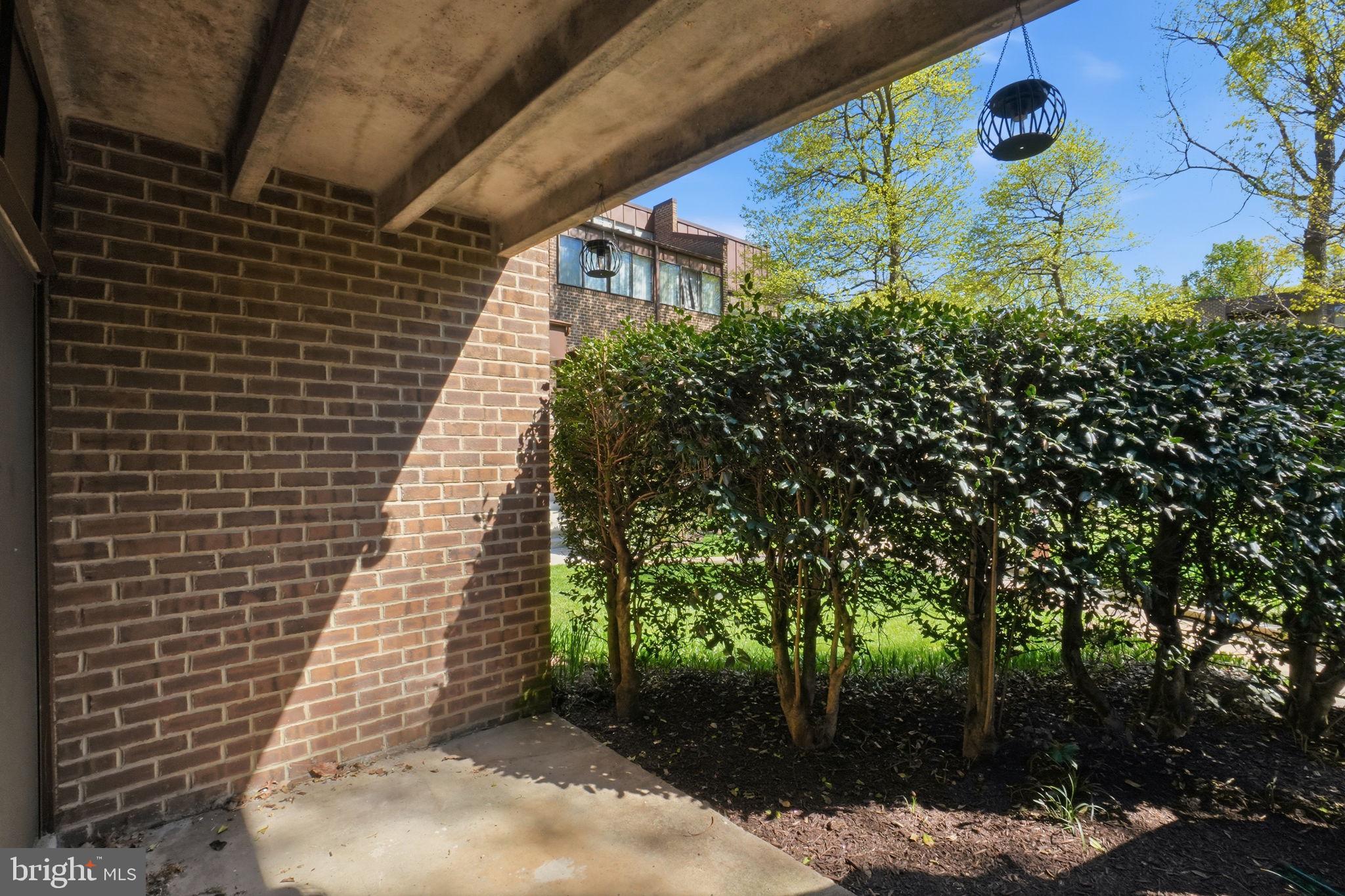 11228 Chestnut Grove Square, Unit 132 Reston, VA 20190 - Photo 18 of 25 Serene outdoor retreat with greenery.
