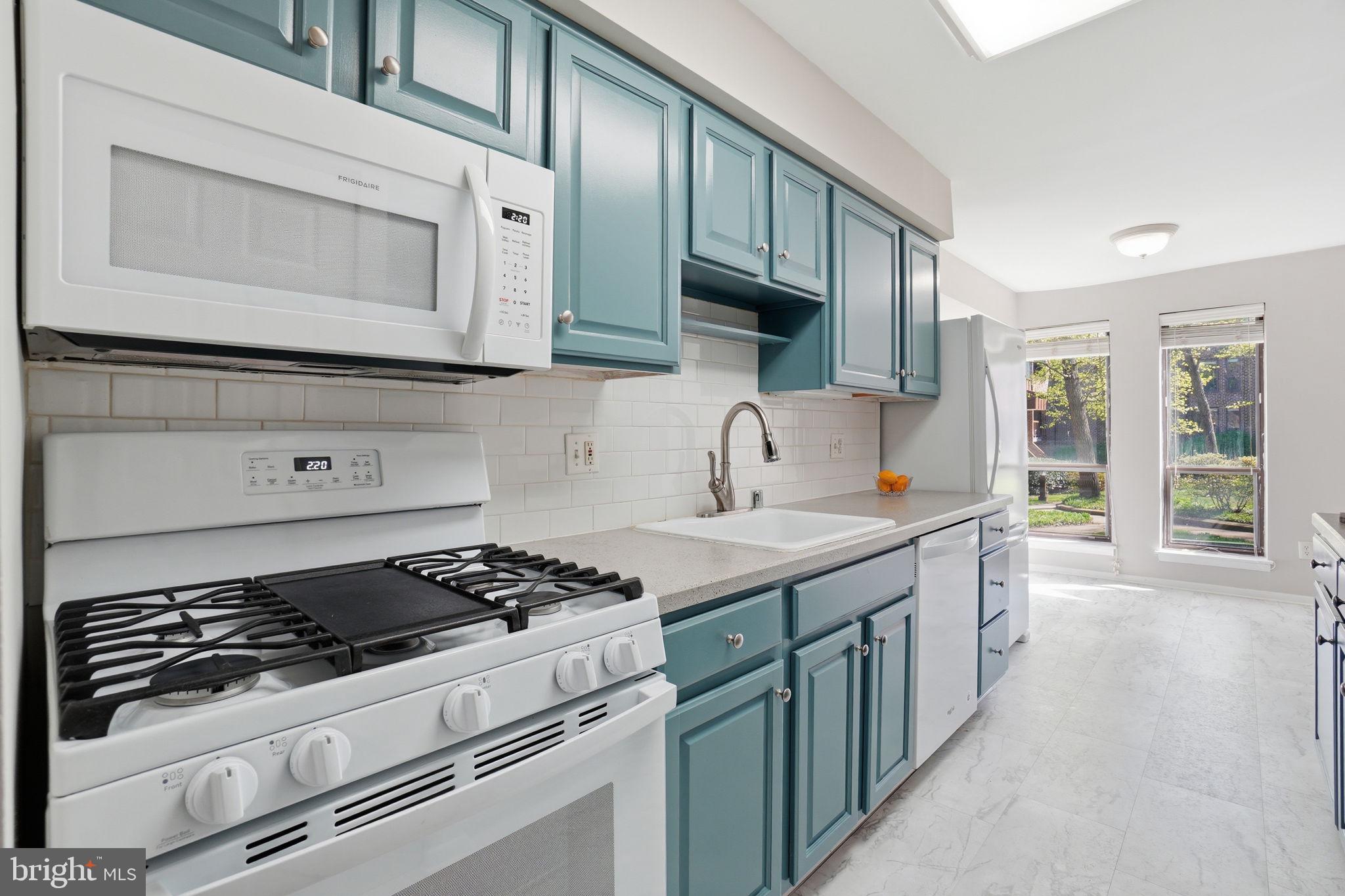 11228 Chestnut Grove Square, Unit 132 Reston, VA 20190 - Photo 3 of 25 Bright and airy modern kitchen space.