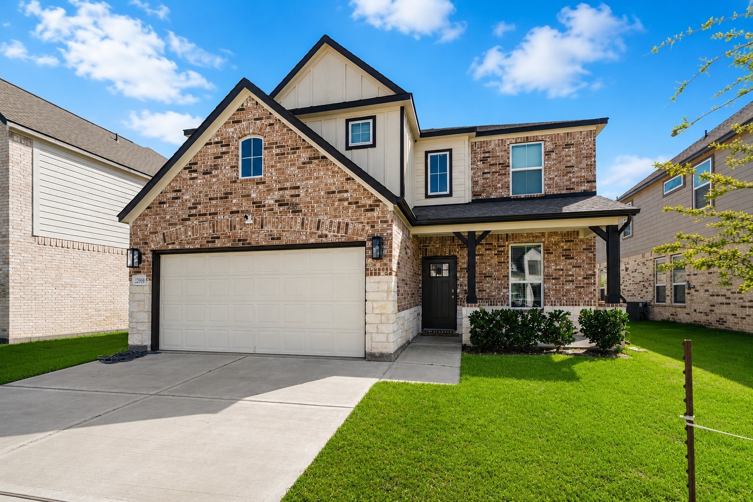 From the moment you arrive, the blend of brick and stone, welcoming front porch, and beautifully maintained landscaping create the kind of curb appeal that instantly feels like home.