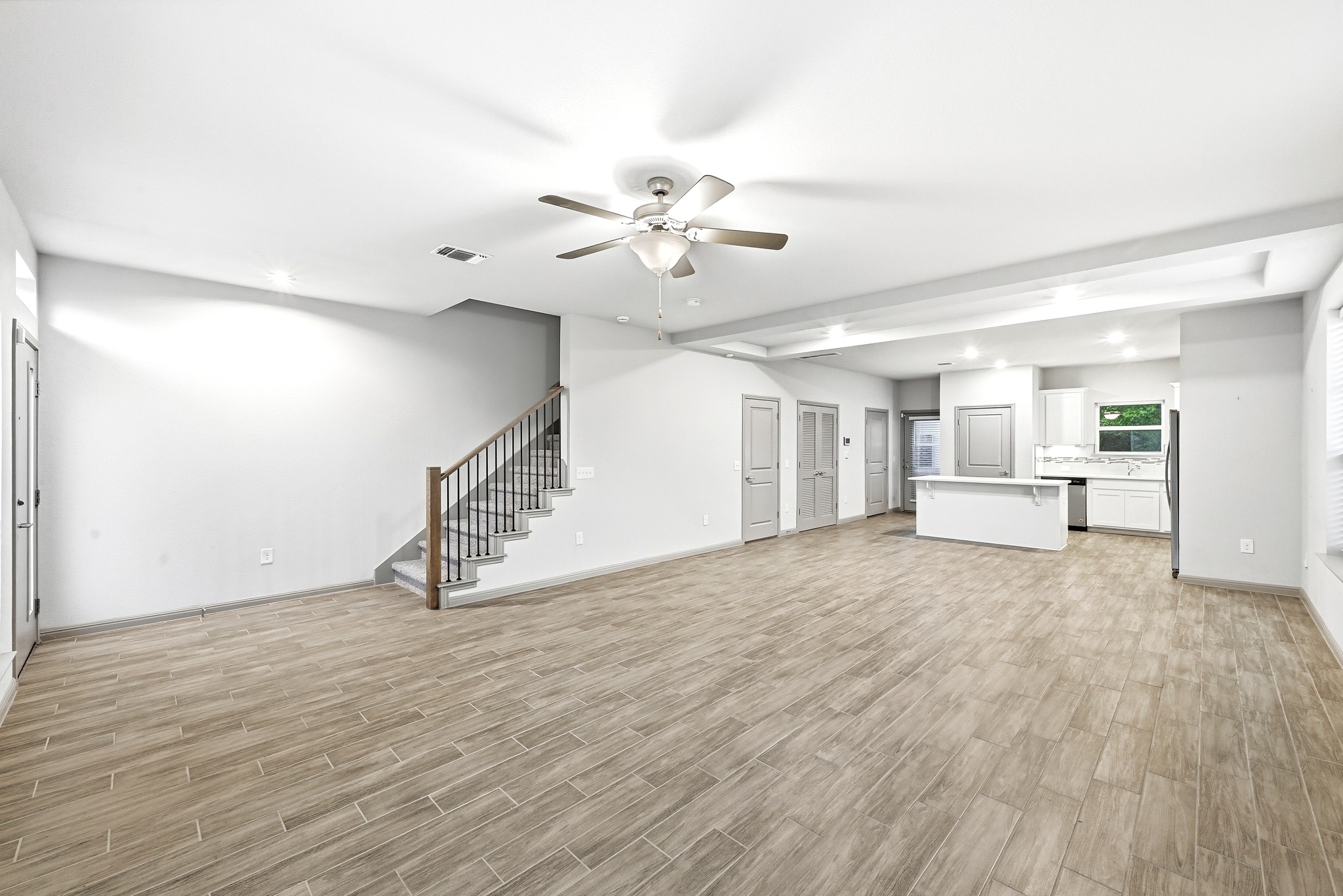 5517 Charles Merle Dr., Unit B Austin, TX 78747 - Photo 4 of 25 a view of an empty room with a window and a ceiling fan