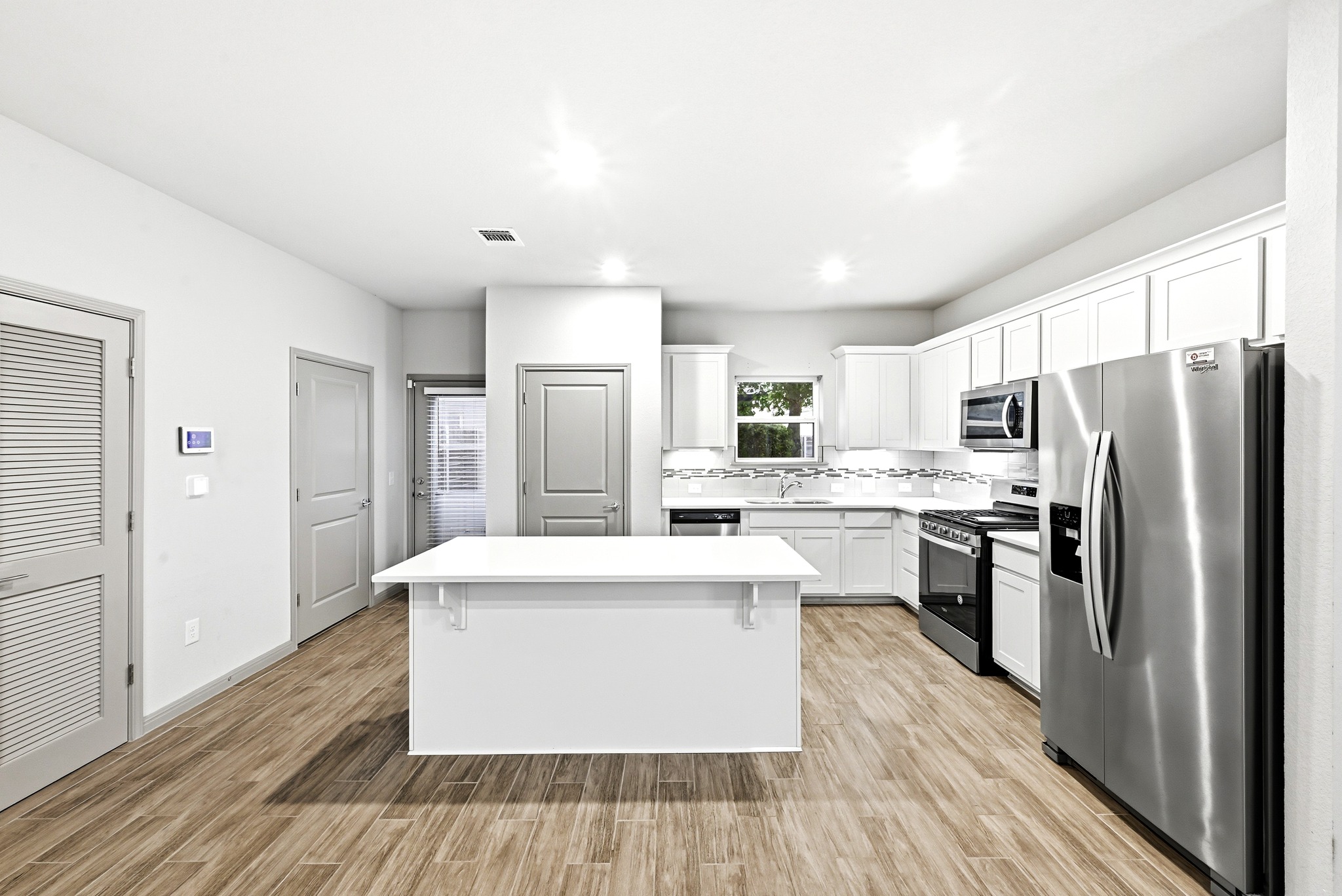 5517 Charles Merle Dr., Unit B Austin, TX 78747 - Photo 5 of 25 a kitchen with stainless steel appliances a refrigerator sink and stove