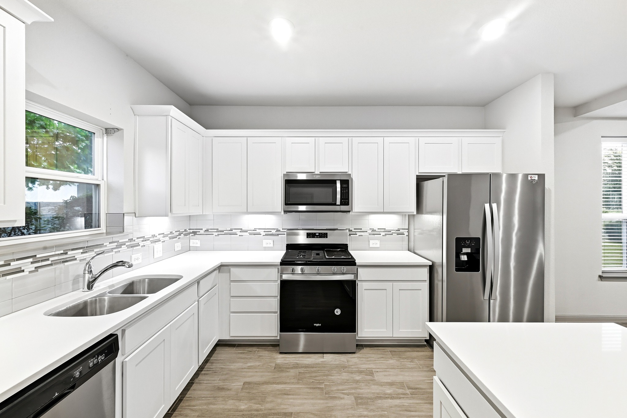 5517 Charles Merle Dr., Unit B Austin, TX 78747 - Photo 6 of 25 a kitchen with a sink stove and refrigerator