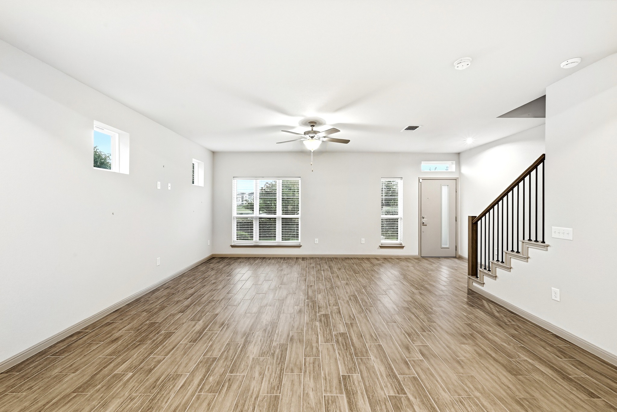 5517 Charles Merle Dr., Unit B Austin, TX 78747 - Photo 7 of 25 a view of an empty room with wooden floor and a window