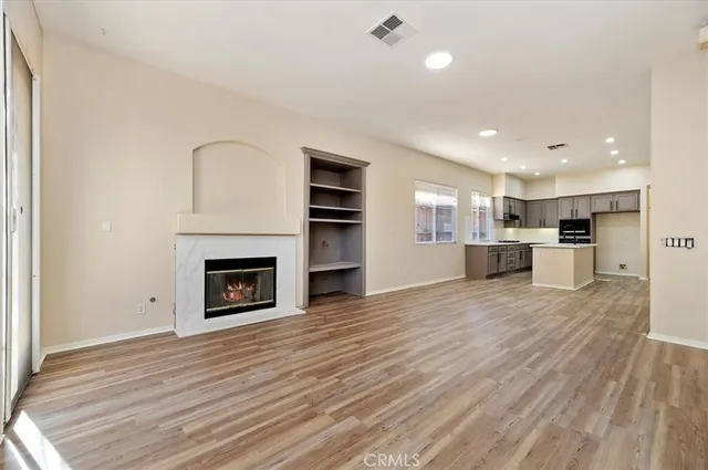 a view of a room with kitchen and fireplace
