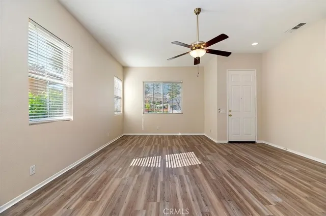 wooden floor in an empty room with a window
