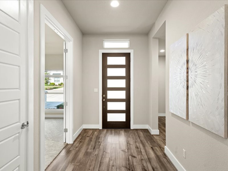 227 Bridge Water Loop Dripping Springs, TX 78620 - Photo 3 of 40 an empty room with wooden floor and windows