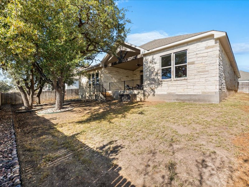 227 Bridge Water Loop Dripping Springs, TX 78620 - Photo 35 of 40 a backyard of a house with large trees