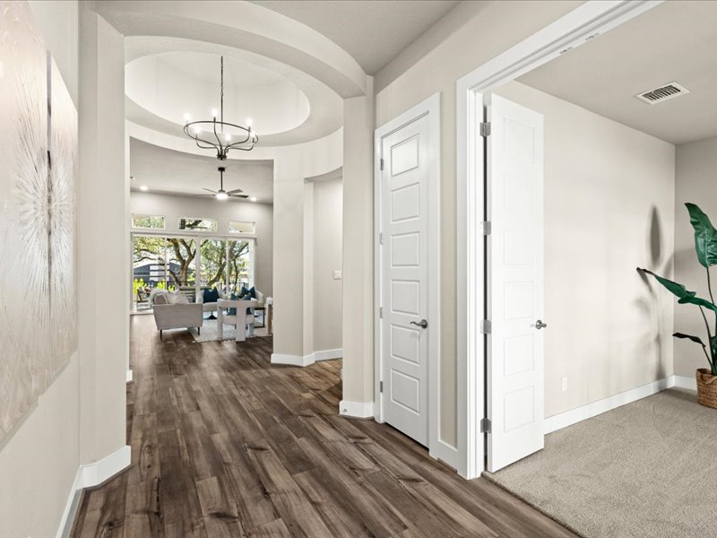 227 Bridge Water Loop Dripping Springs, TX 78620 - Photo 5 of 40 a view of a livingroom with wooden floor and a kitchen space