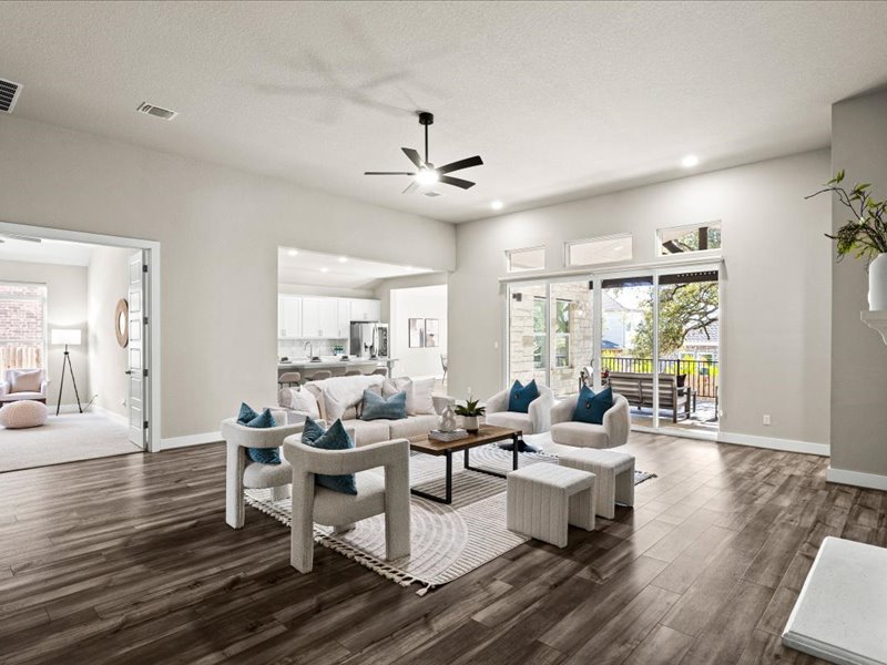 227 Bridge Water Loop Dripping Springs, TX 78620 - Photo 8 of 40 a living room with fireplace furniture and a wooden floor