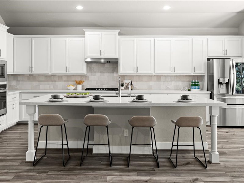 227 Bridge Water Loop Dripping Springs, TX 78620 - Photo 10 of 40 a kitchen with granite countertop a sink counter and chairs