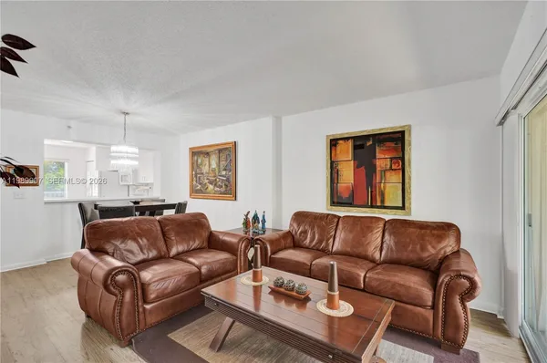 a living room with furniture a couch and window