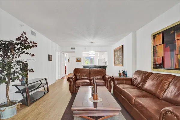 a living room with furniture or couch and a potted plant